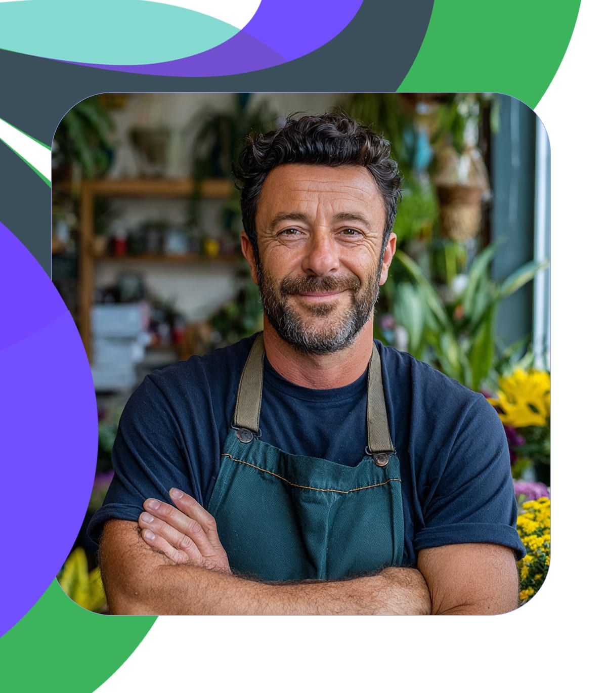 male florist facing camera in his shop with violet, green and mint motif.
