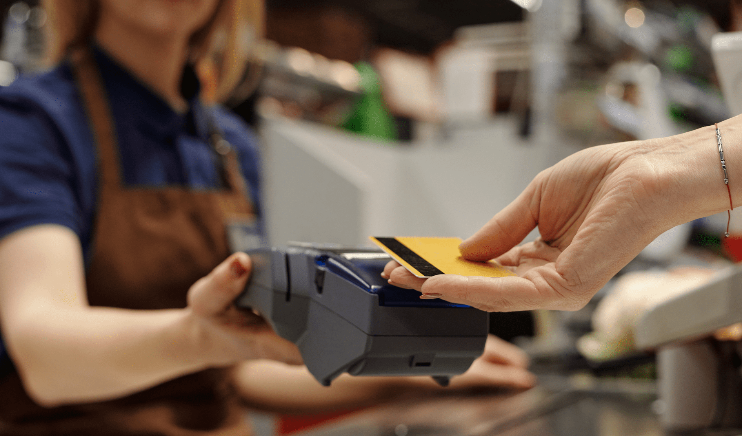 Customer tapping card on POS system while florist completes checkout