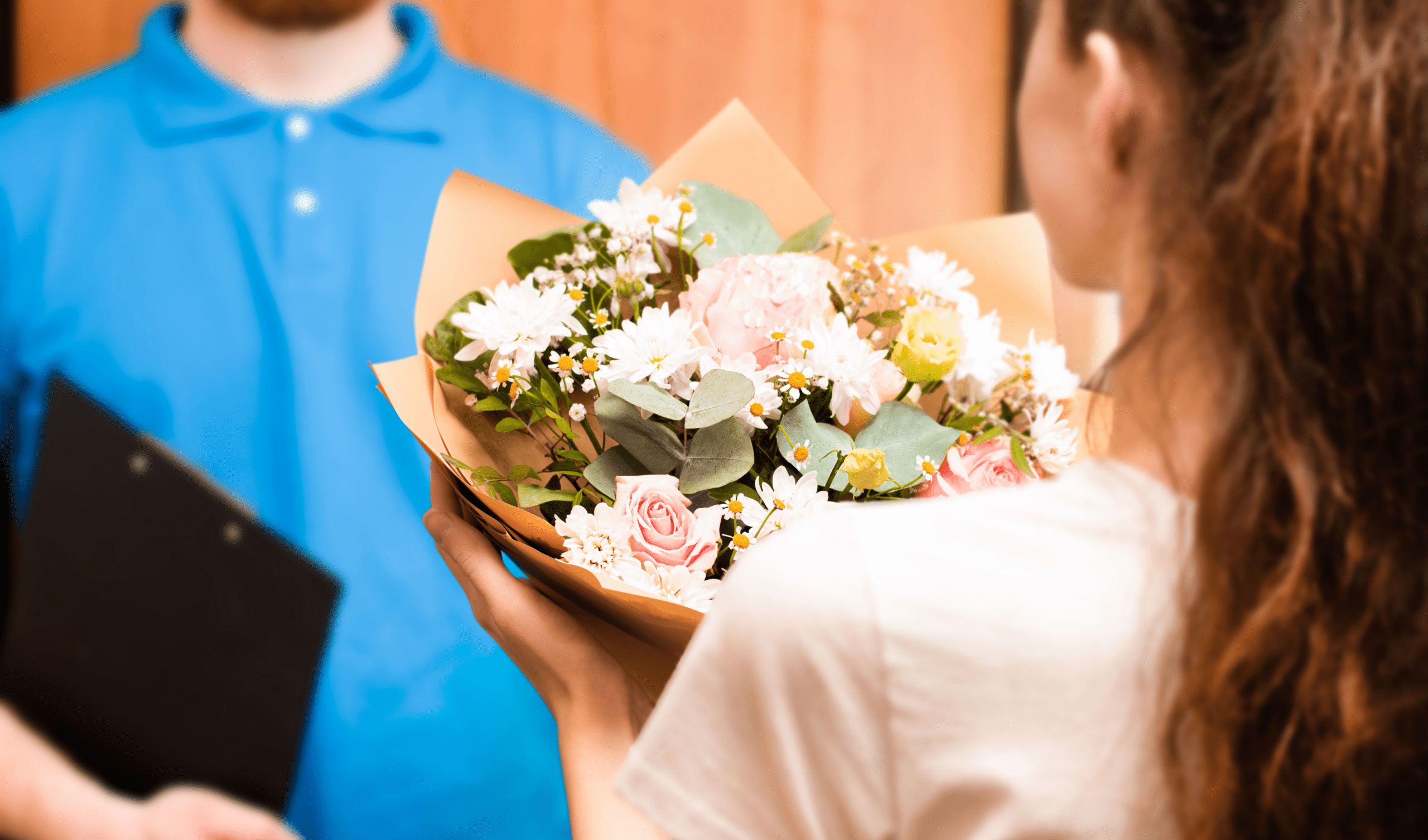 Delivery driver handing bouquet to customer for order fulfillment